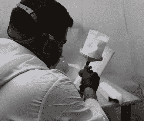 Ultrasound Refurbishing technician painting ultrasound panels
